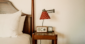 Ocean View Guest Room bedside table with clock and radio
